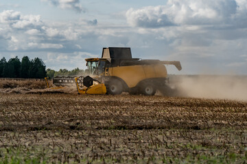 Combine harvester in action cutting crops and separating grain, modern agricultural machinery for...