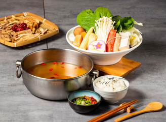 Qi Tonifying Herbal Soup Base Hot Pot Set with Assorted Ingredients and Dipping Sauce isolated on background side view of taiwan food