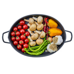 Mixed fresh vegetables in a cooking pan on a wooden table