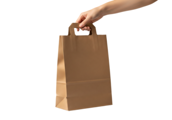 Woman's hand holding a brown paper shopping bag with handles. Isolated on transparent background, png