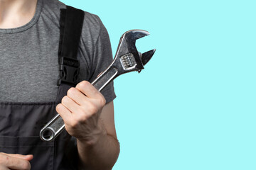 A young male plumber with a plumbing tool. Isolation.