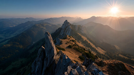 Majestic mountain peaks bathed in golden sunrise light with hazy valleys below golden light