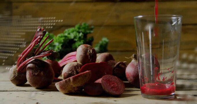 Digital overlay appearing after delay over beets while red juice pouring into glass for tech fusion