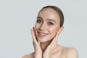 Ideal woman with smooth skin. Rejuvenating facelift lines on a young female face. Graphic lines...