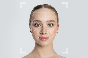 Woman's face in futuristic facial recognition system. Woman with biometric facial scanning,...