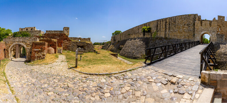 Panoramic view of Kalemegdan Fortress defenses &ndash; Despot&rsquo;s Gate bridge over the moat and cobbled road leading to Zindan Gate, radiating historic might under Belgrade&rsquo;s summer sun.