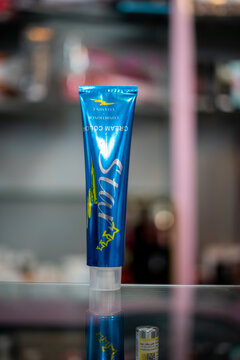 Amsterdam, Netherlands april 10, 2025. baran hair color cream in a metallic blue tube with striking design, placed on a reflective shelf. Offers bold, intense blue tones with conditioning