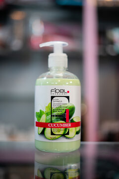 Amsterdam, Netherlands april 10, 2025. Fidel brand cucumber moisturizing body lotion in a pump dispenser, placed on a reflective shelf. The label features fresh cucumber imagery, emphasizing