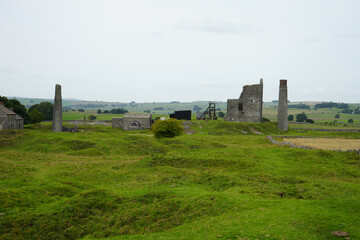 Magpie Mine, The Peak District, England - August 6 2025: Historic stone mine ruins on green hills...