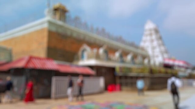 Bokeh view of devotees visit Balaji temple at Tirumala hill. The most visited place of Hindu pilgrimage. Sri Venkateswara Swamy Vaari Temple, Tirumala, Tirupati, India. Blurred background footage.