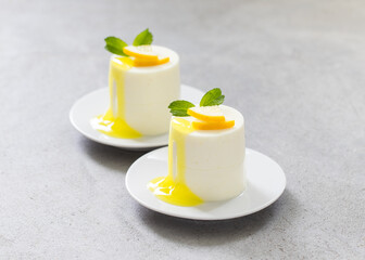 Lemon cream pudding, Panna Cotta with sauce, cylindrical shape. Close-up	