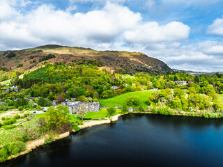 Farms and Mountains over road A591 from a drone, Grasmere Lake, Grasmere, Ambleside, Lake District, Westmorland, Cumbria, UK