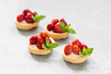 Round Strawberry tartlet. Light gray background. Close up