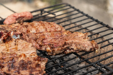 Two large, juicy beef steaks with beautiful char marks are cooked to perfection on a rustic...