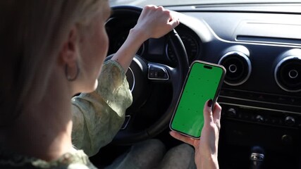A Compelling Visual of a Driver Engaging with a Smartphone Featuring a Green Screen While Navigating the Road, Highlighting Distracted Driving Risks and Safety Precautions