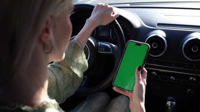 A Compelling Visual of a Driver Engaging with a Smartphone Featuring a Green Screen While Navigating the Road, Highlighting Distracted Driving Risks and Safety Precautions