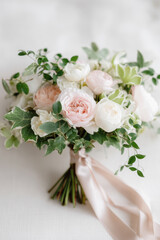 Fresh garden-style bouquet featuring soft blush and white roses with lush greenery