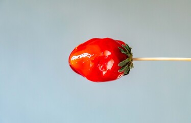 The best sweet in the world, the iconic dessert strawberry of love on a stick, fresh strawberry,...
