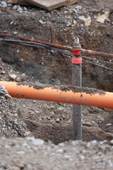 Pipe is sticking out of the ground in a muddy area