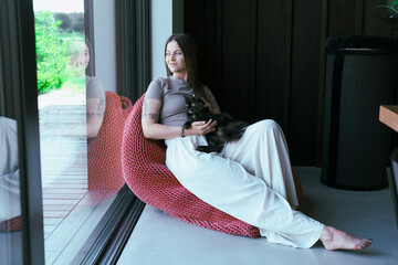 Attractive girl embracing her pet with smile. woman playing with cat. Human-animal relationships....