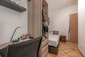 Teen's bedroom with an open wardrobe with shelves and drawers, perfect for organization and decoration