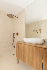 Contemporary bathroom with rectangular porcelain sink, chrome wall-mounted mixer tap, and corner shower enclosure