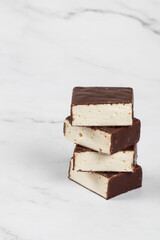Chocolate candy. Bird's milk. Souffle in chocolate glaze. White background. Copy space