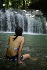 Female tourists exploring Siete Altares, which is a natural attraction located near Livingston, Guatemala, featuring seven freshwater pools and waterfalls set within a lush rainforest.