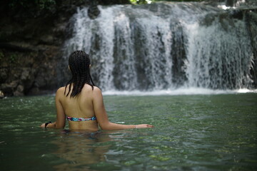 Female tourists exploring Siete Altares, which is a natural attraction located near Livingston, Guatemala, featuring seven freshwater pools and waterfalls set within a lush rainforest.