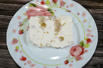 A slice of White Feta cheese with slices of olive, Feta is a Greek brined white cheese made from...