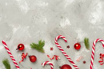 Christmas composition with lollipops on concrete background, top view