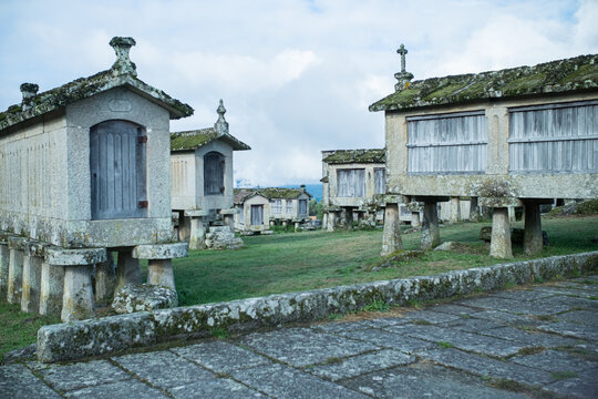 A collection of old stone granaries under a cloudy sky, a journey into the past.
