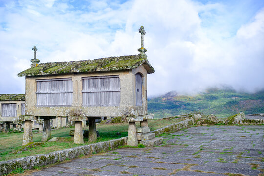 Stone buildings on pillars in a green field, smart ancient design.