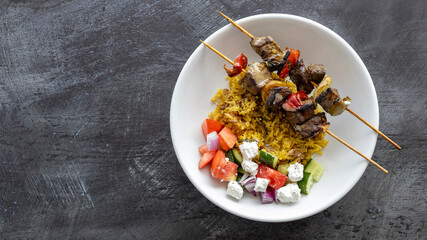 Plate of Mediterranean Beef Kebabs with a Cucumber Tomato Salad