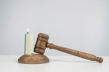 Judge's gavel and e-cigarette. Smoking ban. Tobacco heating systems. 