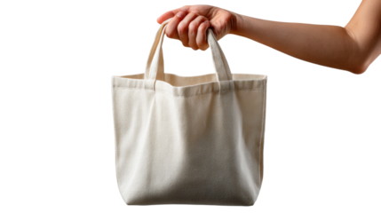 Hand Holding Canvas Bag: The shot captures a hand confidently holding a blank canvas bag, ideal for showcasing eco-friendly lifestyle, promoting brand identity, or symbolizing sustainability.