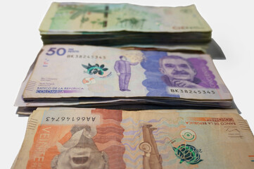 Concepts about Colombian money. Colombian pesos stacks Banknotes background.