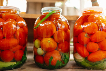 Colorful jars filled with homemade canned tomatoes and vegetables, prepared for longterm...