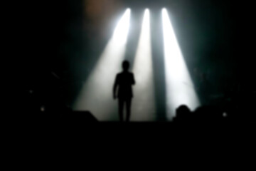 Blurred background rock concert with light background, concert in hall at night. people enjoying...