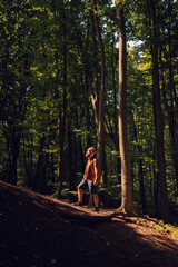 Fototapeta premium A person peacefully enjoying tranquility amid lush trees and greenery, capturing the beautiful essence of nature