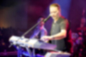Blurred background rock concert with light background, concert in hall at night. people enjoying...