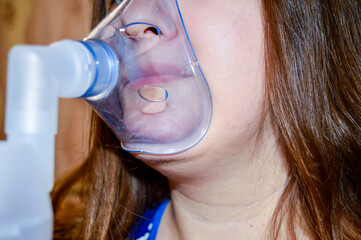a person using a nebulizer mask healthcare and medical services respiratory care asthma treatment...