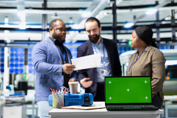 Professionals engineering group reviews solar panels next to chroma key, showcasing unity in green technology and eco friendly renewable energy. Operational leadership in manufacturing industry.