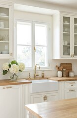 Contemporary Provencal kitchen features matte cream cabinets with glass doors, wooden countertop. Brass hardware accents clean design. Bright daylight fills space, farmhouse sink, elegant faucet.