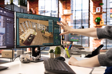 Freelancer designs a home interior using architectural software on her PC, program provides a...