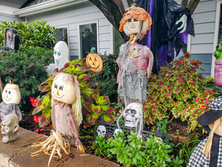 Fun Halloween Garden Decor with Pumpkins and Ghosts. Colorful and playful decorations in a suburban...