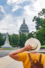 tourist wearing a hat looks at the Capitol in Washington, D.C.