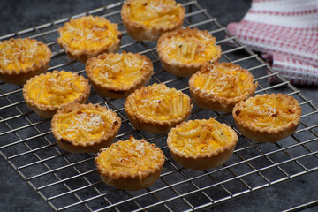 Macaroni and cheese tartlets  on a cookie rack, cooling