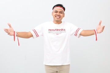 Happy and friendly Indonesian man with red and white ribbon celebrating Indonesian independence day...