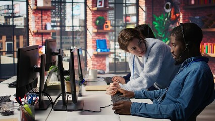 Call center manager teaching intern how to track clients shipment parcels. Customer center team...